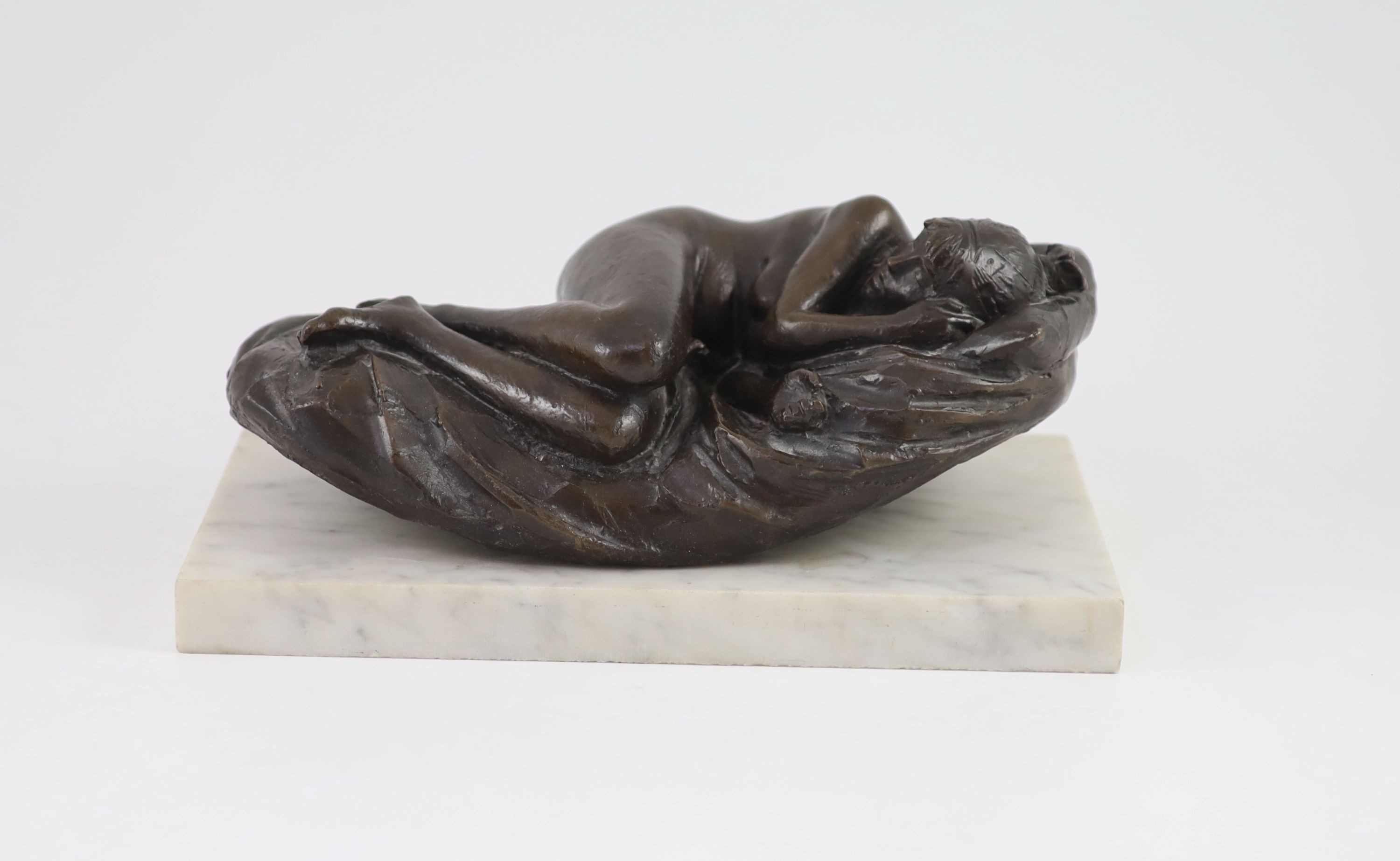 James W. Butler. RA., A bronze model of a sleeping girl, width 31cm depth 18cm height 13cm